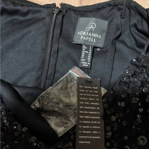 Shiny sequins and a sheer asymmetrical hem accentuate this sleeveless dress - Picture 5 of 6